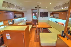 Interior of 2013 Beneteau Oceanis 41 yacht, featuring modern wood finish and cozy seating area.