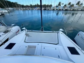 Leopard 40 catamaran docked in marina, surrounded by sailboats and palm trees, 2019 model.