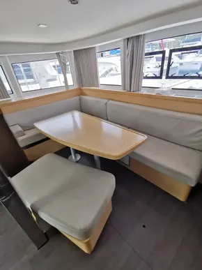 Interior of 2020 Lagoon 42 catamaran with modern dining area and large windows.