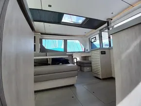 Spacious interior of 2019 Leopard 45 catamaran with modern furnishings and large windows.