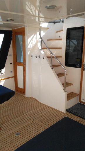 Safe access to flybridge from aft cockpit with enclosure with weather door  closed