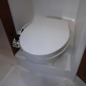 Beneteau Oceanis 41.1 2019 yacht bathroom with white marine toilet.