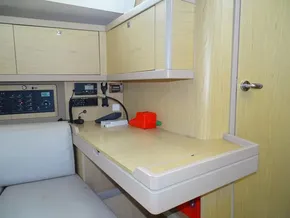 Interior of 2017 Beneteau Oceanis 45 yacht with navigation station and light wood cabinetry.