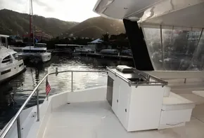2018 Leopard 43 Powercat yacht docked at a marina with scenic mountain views.