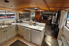 Interior of a 1926 Dutch Barge Luxemotor with kitchen and living area.