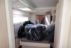 Interior cabin of 2015 Leopard 51 Powercat with bags on bed.