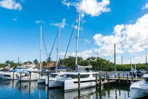Marina with 2025 Leopard 46 sailboat under a clear blue sky.