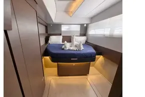 Luxurious cabin interior of 2021 Leopard 50 yacht with elegant bedding and ambient lighting.