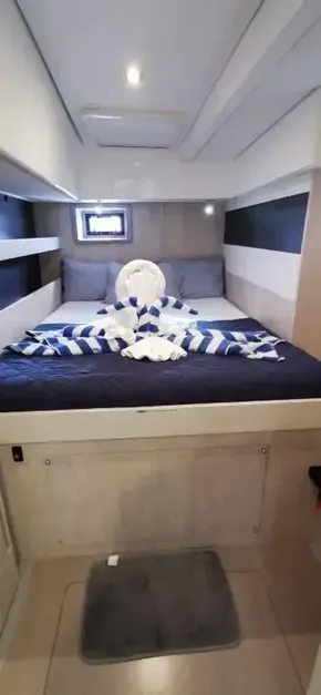 2019 Leopard 51 Powercat bedroom with cozy bed and decorative towels.