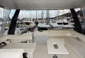 Flybridge view of 2018 Leopard 43 Powercat in marina with surrounding yachts.