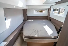 Modern interior cabin of 2025 Leopard 46 yacht with cozy bed and natural light.
