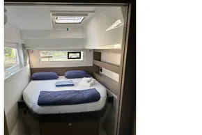 Cozy bedroom in 2022 Leopard 42 yacht with modern design and natural light.