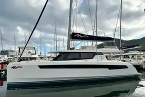 2021 Leopard 50 catamaran docked at marina, surrounded by other boats under cloudy sky.