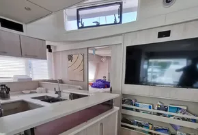 Modern interior of 2016 Leopard 58 yacht with kitchen and entertainment area.