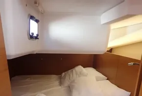 Cozy cabin interior of 2019 Jeanneau Sun Odyssey 440 with neatly arranged bedding.