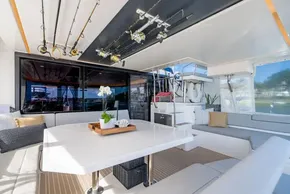 Luxurious 2022 Leopard 50 yacht interior with fishing rods, dining area, and modern decor.