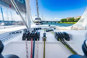 Sailing yacht deck view, Leopard 50, 2022 model, with ropes and marina backdrop.
