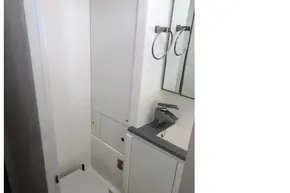 Compact bathroom in 2020 Leopard 40 yacht with modern fixtures and white cabinetry.