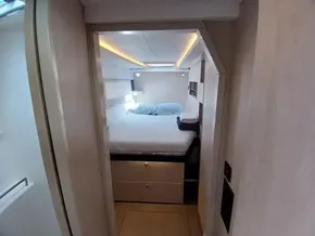 Cozy bedroom in 2019 Leopard 45 yacht with modern lighting and storage.