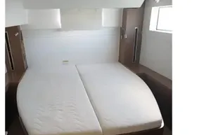 Interior cabin of 2020 Lagoon 46 catamaran with double bed and modern design.