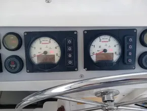 Control panel of a 2021 Leopard 40 boat with gauges and steering wheel.
