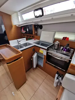 Modern kitchen in 2020 Jeanneau Sun Odyssey 410 yacht with appliances and storage.