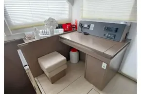 Modern interior of 2021 Leopard 50 yacht with navigation station and seating.