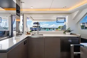 Modern kitchen interior on a 2022 Leopard 50 yacht, featuring sleek design and marina view.