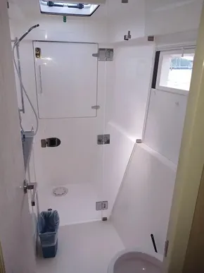 Bathroom interior of 2021 Leopard 40 catamaran, featuring shower and window.