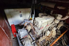Engine room of a 1926 Dutch Barge Luxemotor, showcasing vintage machinery and components.