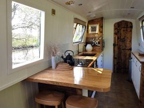 Galley kitchen with side hatch opening over breakfast bar
