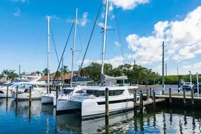 2025 Leopard 46 catamaran docked at marina under blue sky.