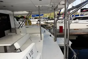 2018 Leopard 43 Powercat yacht docked at marina, featuring spacious deck and seating area.