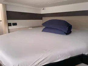 Modern bedroom interior in a 2020 Leopard 50 yacht with neatly arranged pillows.