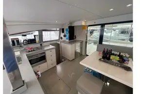 Modern kitchen interior of 2020 Leopard 40 catamaran with appliances and dining area.