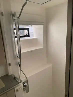 Compact shower area in a 2020 Leopard 50 yacht, featuring a modern design and window.