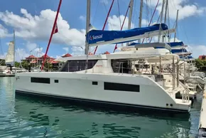 2021 Leopard 45 catamaran docked at marina under clear blue sky.