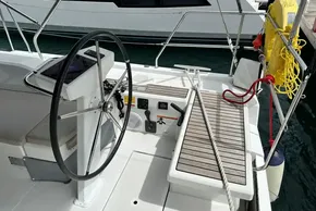 Cockpit of 2023 Beneteau Oceanis 51.1 sailboat with steering wheel and deck details.