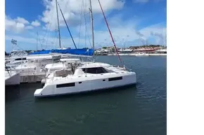 2018 Leopard 45 catamaran docked in a sunny marina with blue skies.