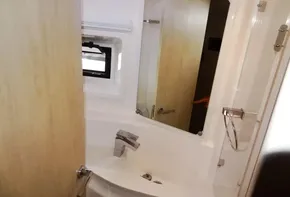 2015 Leopard 51 Powercat bathroom with sink, mirror, and window.