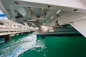 Underneath view of a 2019 Leopard 50 catamaran docked in clear turquoise water.