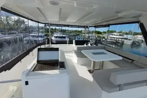 2024 Leopard 40 Powercat interior with seating, grill, and marina view.