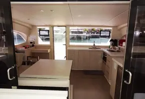 Interior of 2017 Leopard 43 Powercat yacht with modern kitchen and dining area.