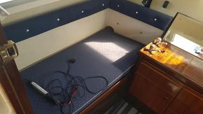 1982 Fairline Mirage 29 Aft Cabin interior with blue upholstery and wooden cabinetry.