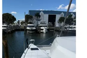 2025 Leopard 46 yacht docked at marina, clear sky, calm water, modern design.