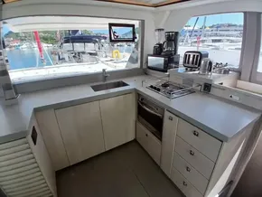 Modern kitchen in 2019 Leopard 45 catamaran with appliances and marina view.