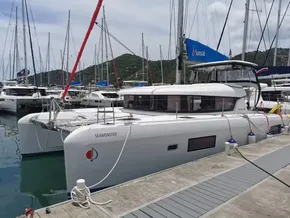 2020 Lagoon 42 catamaran docked at marina with scenic mountain backdrop.