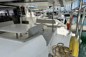 Luxurious Leopard 50 catamaran deck with seating, table, and marina view, 2021 model.