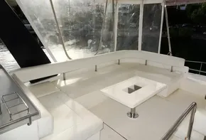 2018 Leopard 43 Powercat yacht with spacious outdoor seating area and table.