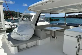 2025 Robertson and Caine Leopard 46 Powercat yacht interior with seating and table, docked at marina.
